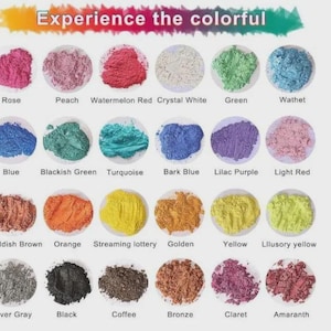 May include: A collection of colorful powders in small, round containers. The image features a variety of colors, including rose, peach, watermelon red, crystal white, green, and blue. Text at the top reads "Experience the colorful."