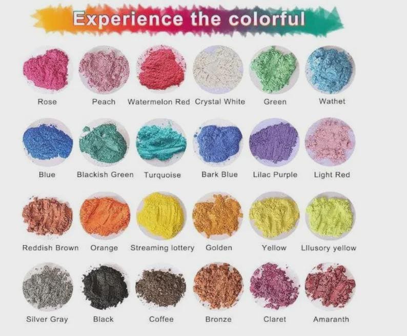 May include: A collection of colorful powders in small, round containers. The image features a variety of colors, including rose, peach, watermelon red, crystal white, green, and blue. Text at the top reads "Experience the colorful."