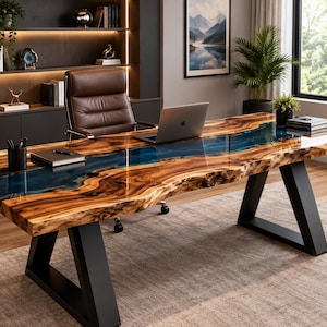 May include: A large desk featuring a natural live-edge wood slab with a central translucent blue resin river inlay. The desk is supported by two black metal trapezoidal legs and holds a silver laptop, a black pen holder, and a notebook.