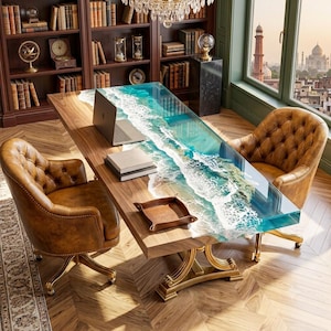 May include: A rectangular wooden desk featuring a central resin inlay that mimics ocean waves with white foam and turquoise water. The desk has a gold-toned metal base and is accompanied by two brown tufted leather chairs with gold-toned metal legs.