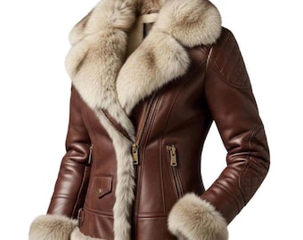 May include: A brown leather jacket with a faux fur collar and cuffs. The jacket features a diagonal zipper, two front pockets, and quilted shoulder detailing. The fur trim is a light beige color.