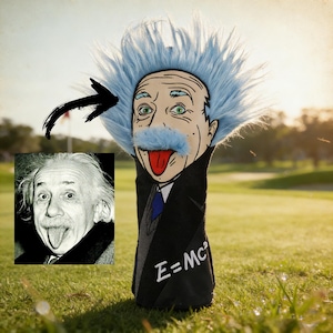 May include: A novelty golf club headcover featuring a cartoon likeness of Albert Einstein with his tongue sticking out. The headcover has a blue faux-fur hair and mustache, and a black coat with the equation E=MC².