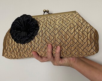 Fancy gold colored evening fabric clutch with kiss lock clasp