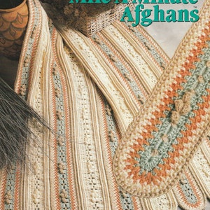May include: A crochet pattern book titled "Annie's Mile-A-Minute Afghans" with a picture of a crocheted afghan in beige, green, and orange colors.