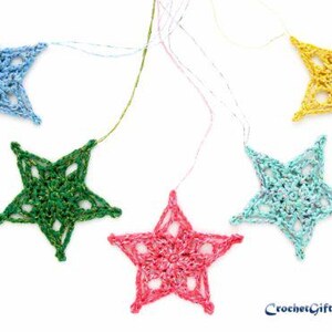 May include: Five crocheted star ornaments in various colors: blue, green, pink, light blue, and yellow. Each star is connected to a string for hanging. The text "CrochetGifts_Shop" is visible in the bottom right corner.