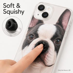 May include: A clear phone case featuring a high-resolution print of a French Bulldog face. The case includes a raised, soft, and squishy 3D black dog nose element. Text on the image reads Soft & Squishy and Only the Nose is 3D.