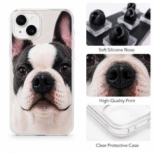 May include: A clear protective phone case featuring a high-quality print of a black and white French Bulldog face. The design includes a tactile, soft silicone nose element on the dog's snout, adding a three-dimensional texture to the phone cover.