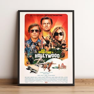 May include: A framed movie poster for "Once Upon a Time in Hollywood" featuring Leonardo DiCaprio, Brad Pitt, and Margot Robbie. The poster has a retro design with a red and orange background and the film's title prominently displayed.