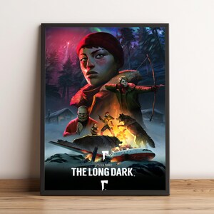 Puede incluir: Póster enmarcado con ilustraciones del videojuego "The Long Dark". La imagen muestra a una mujer con gorro rojo, un hombre con arco y flecha y un lobo. El texto "THE LONG DARK" está en la parte inferior.