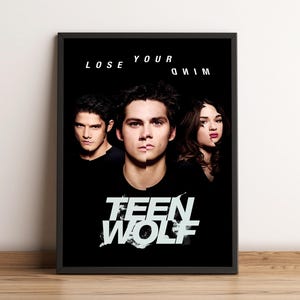 May include: A framed poster featuring three people with split faces against a black background. The text "LOSE YOUR MIND" is above the subjects, and "TEEN WOLF" is written in a stylized font below.