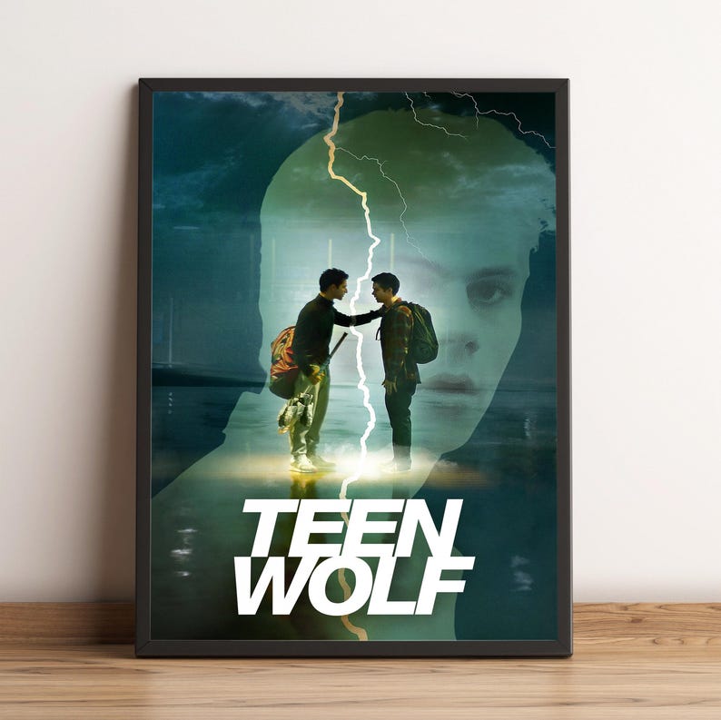 May include: Framed poster featuring two young men in a dramatic scene with a lightning bolt overlay. The poster has a dark, moody color palette with the words "TEEN WOLF" in bold white letters at the bottom. The background features a large face.