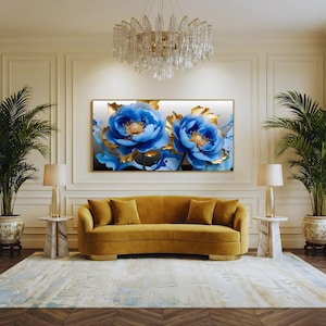 May include: A luxurious living room featuring a mustard-yellow sofa, a large floral painting with blue and gold accents, and a crystal chandelier. Two potted plants flank the sofa, and a patterned rug covers the floor.