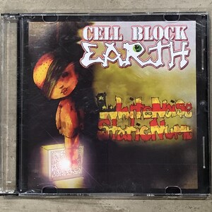 Op de afbeelding: Een cd-hoesje met het album "White Noise Static Numb" van Cell Block Earth. De cover bevat een cartoonfiguur, een televisiescherm en de bandnaam in een gestileerd lettertype. Het kleurenpalet wordt gedomineerd door oranje, geel en bruin.