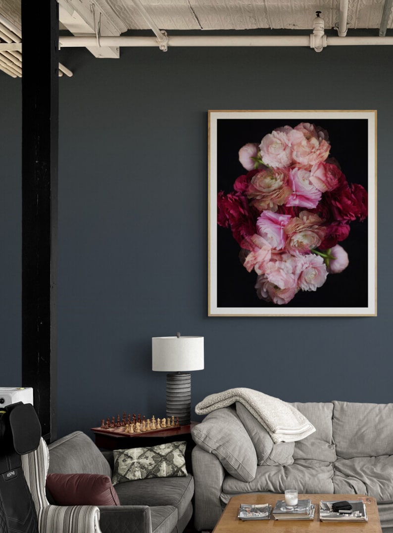 May include: A framed print of a floral arrangement featuring pink and red flowers against a black background. The flowers are arranged in a symmetrical pattern, creating a visually appealing and artistic composition.