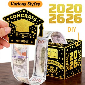Puede incluir: Una caja de regalo de dinero de graduación DIY con un esquema de color negro y dorado. La caja presenta los números "2026" y la palabra "Grad" en dorado. También se ve una tarjeta en forma de birrete con las palabras "Congrats" y "You Did It".