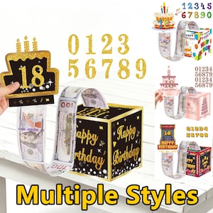 May include: A black and gold "Happy Birthday" money box with a slot for inserting banknotes. The image shows multiple styles of birthday money boxes, including a cake-shaped card and gold glitter numbers. The text "Multiple Styles" is at the bottom.