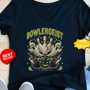 May include: Navy blue V-neck t-shirt with a Halloween-themed graphic. The design features bowling pins, ghosts, and a jack-o'-lantern, with the word "BOWLGEIST" in green. A "Best Seller" sticker is visible.