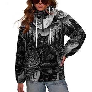 May include: A black and white long-sleeve pullover hoodie featuring a high collar with a zipper and white drawstrings. The fabric displays a detailed graphic print of a black cat wearing a pentagram pendant, set against a forest and moon.