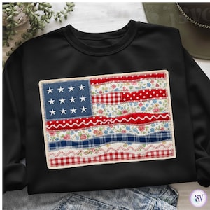 May include: Black sweatshirt with a patchwork design of the American flag. The flag features a blue section with white stars, red and white stripes, and diverse patterned fabrics such as floral, gingham, and polka dots. A patriotic clothing item.