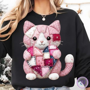 May include: Black sweatshirt featuring a patchwork cat design. The cat is pink, white, and red, holding a patchwork heart. The cat's design includes gingham, floral, and solid fabric patterns. The cat has a sweet expression and whiskers.
