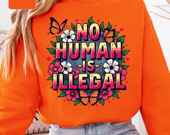 Bluza z napisem „Żaden człowiek nie jest nielegalny”, sweter z kwiatowym nadrukiem praw człowieka, bluza z nadrukiem sprawiedliwości społecznej