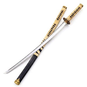 May include: A katana sword with a polished steel blade and a cream-colored wrapped handle. The matching scabbard features a cream-colored wrapped upper section and a smooth black lower section, finished with a decorative gold-toned metal tip.