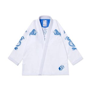 May include: White martial arts uniform with blue snake and dice graphics. The jacket features blue snake designs on the shoulders and sleeves, with dice on the lower front. The collar has a blue lining. This uniform is designed for martial arts.