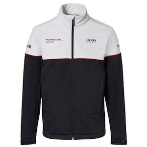 May include: A black, white, and red zip-up jacket with the Porsche Motorsport and BOSS logos. The jacket has a high collar and a red stripe across the chest. The sleeves are black with white accents.