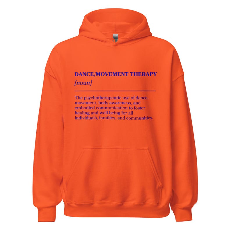 May include: An orange hoodie with a front pocket and a hood. The front of the hoodie features the text "DANCE/MOVEMENT THERAPY [noun]" in blue, along with a definition of the term. The hoodie is made of a soft material.