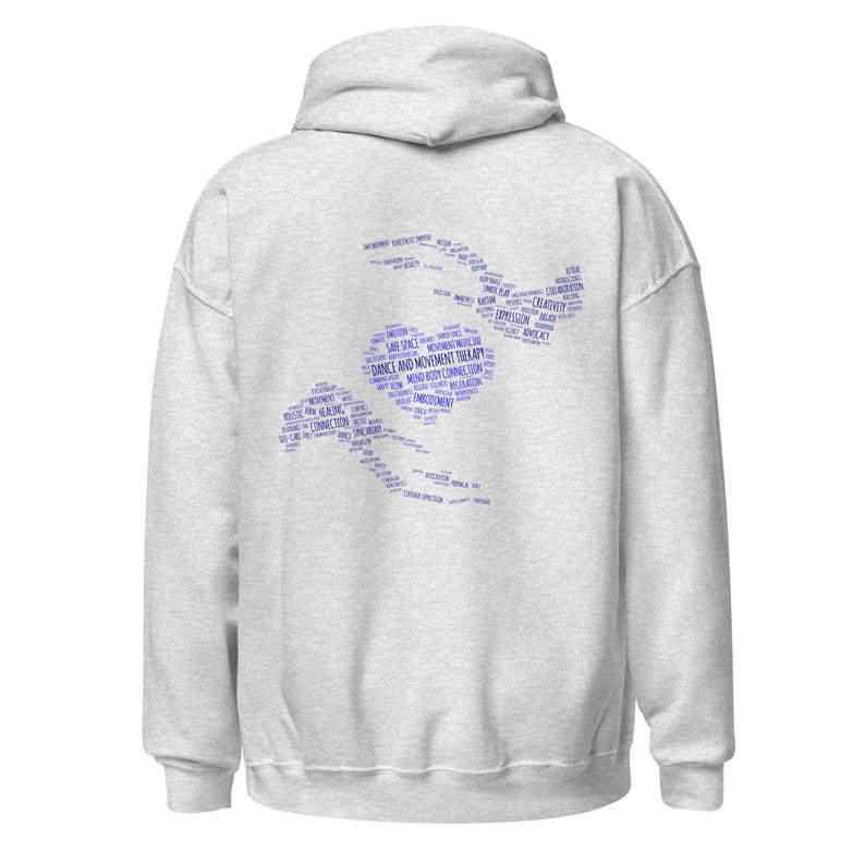 May include: A light gray hoodie with a hood and long sleeves. The back of the hoodie features a blue graphic composed of words related to dance and movement therapy, including "Safe Space" and "Expression."