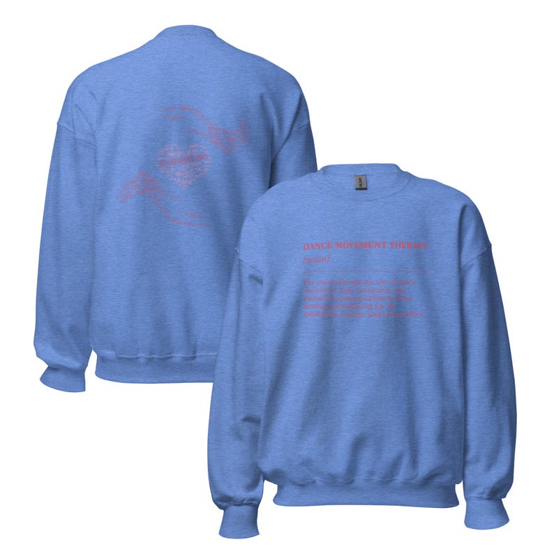 May include: Two light blue sweatshirts. One displays a pink heart design with hands on the back. The other features the text "DANCE MOVEMENT THERAPY (noun)" in pink, along with a definition. The sweatshirts are made of a soft material.
