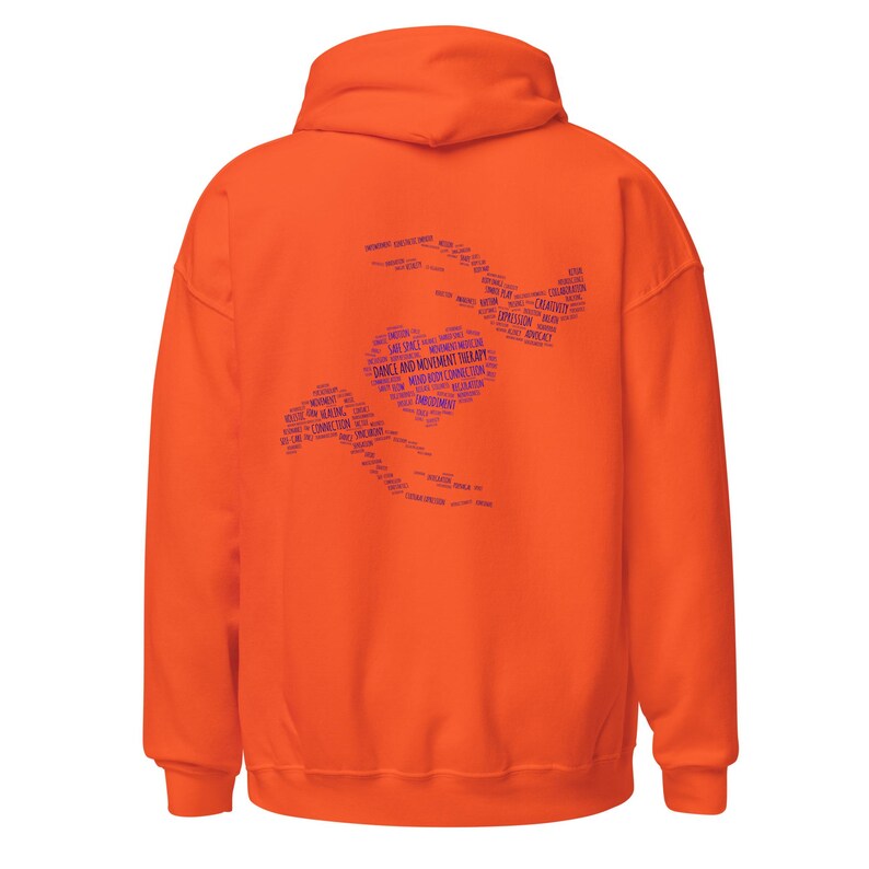 May include: An orange hoodie with a hood and long sleeves. The back of the hoodie features a blue graphic of a heart and two stylized figures, with the words "DANCE AND MOVEMENT THERAPY" and other related terms.