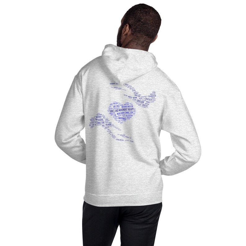 May include: A light gray hoodie with a blue graphic on the back. The graphic is a stylized design with the words "DANCE AND MOVEMENT THERAPY" and other related terms. The hoodie has a hood and long sleeves.