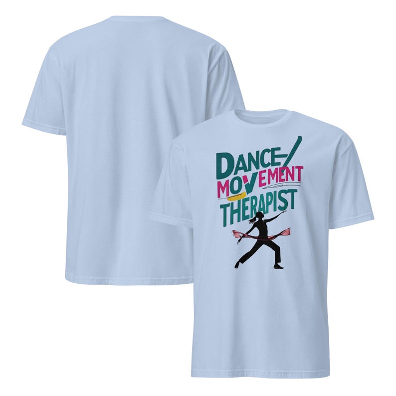 May include: Light blue t-shirts. One shirt displays the text "DANCE MOVEMENT THERAPIST" in green, pink, and yellow, with a silhouette of a person dancing. The other shirt is plain.