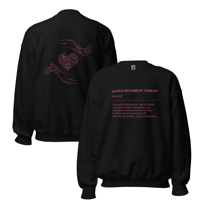 May include: Black sweatshirt with the text "DANCE/MOVEMENT THERAPY [noun]" in pink. The back of the sweatshirt features a heart and hands design in pink. The text describes the psychotherapeutic use of dance for healing and well-being.