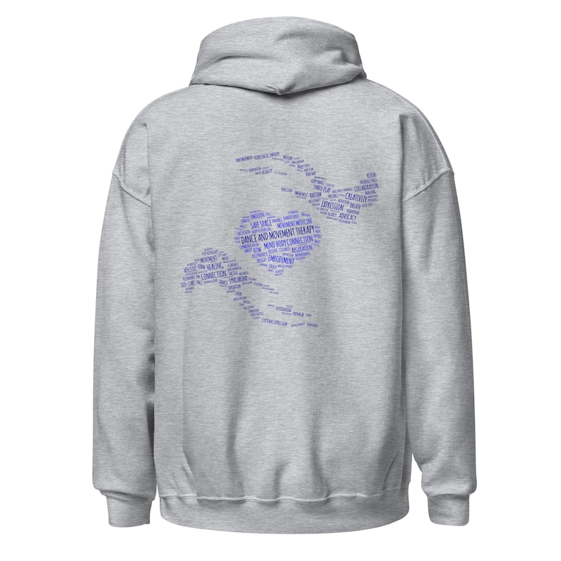 May include: A light gray hoodie with a hood and long sleeves. The back of the hoodie features a blue word cloud design in the shape of a person dancing, with the words "Dance and Movement Therapy" prominently displayed.