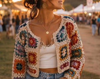 May include: A cropped cardigan made of multi-colored granny square crochet patches in shades of red, orange, blue, and purple, joined by cream-colored yarn. The garment features long sleeves, a scalloped edge, and a front tie closure at the neckline.
