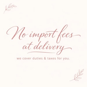 May include: A light beige background with the text "No import fees at delivery" in a cursive, rose-coloured font. The text "we cover duties & taxes for you" is below in a smaller font.