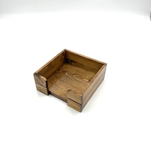 May include: A wooden box with a square shape and a dark brown stain. The box is open and empty.