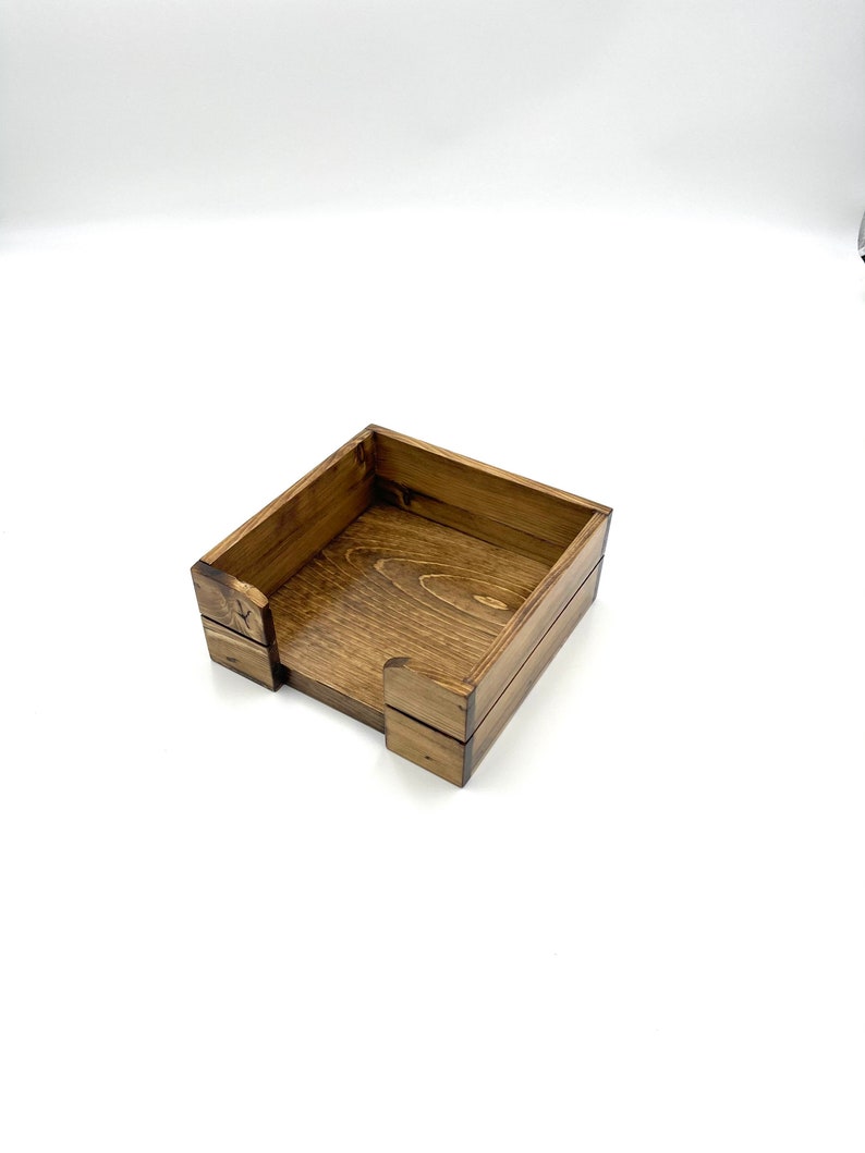 May include: A wooden box with a square shape and a dark brown stain. The box is open and empty.