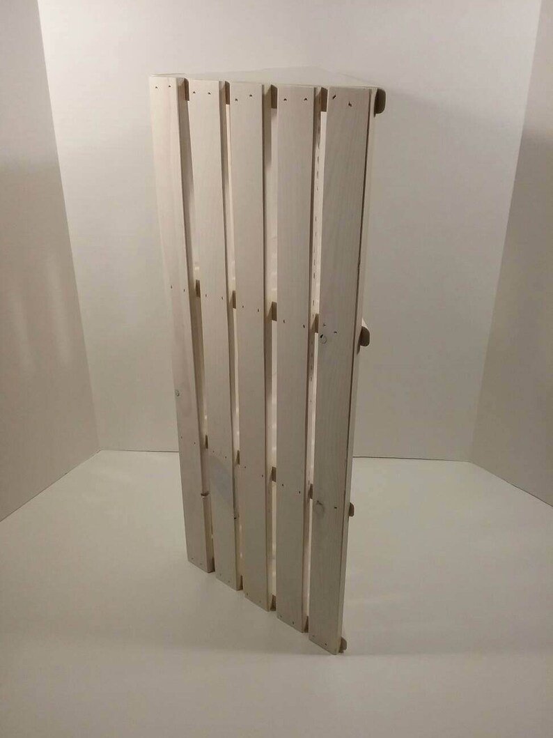 May include: White wooden pallet with a rustic look. The pallet is made of unfinished wood and has a natural wood grain. The pallet is perfect for adding a touch of rustic charm to any home or garden.