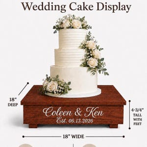 May include: A square wooden wedding cake display stand with a dark brown finish, featuring the engraved text 'Coleen & Ken' and 'Est. 06.13.2026'. It measures 18 inches wide, 18 inches deep, and 4-3/4 inches tall with feet, supporting a three-tier cake.