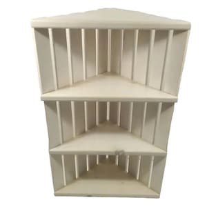 Wooden corner slatted shelf in white stain.  Three shelves.