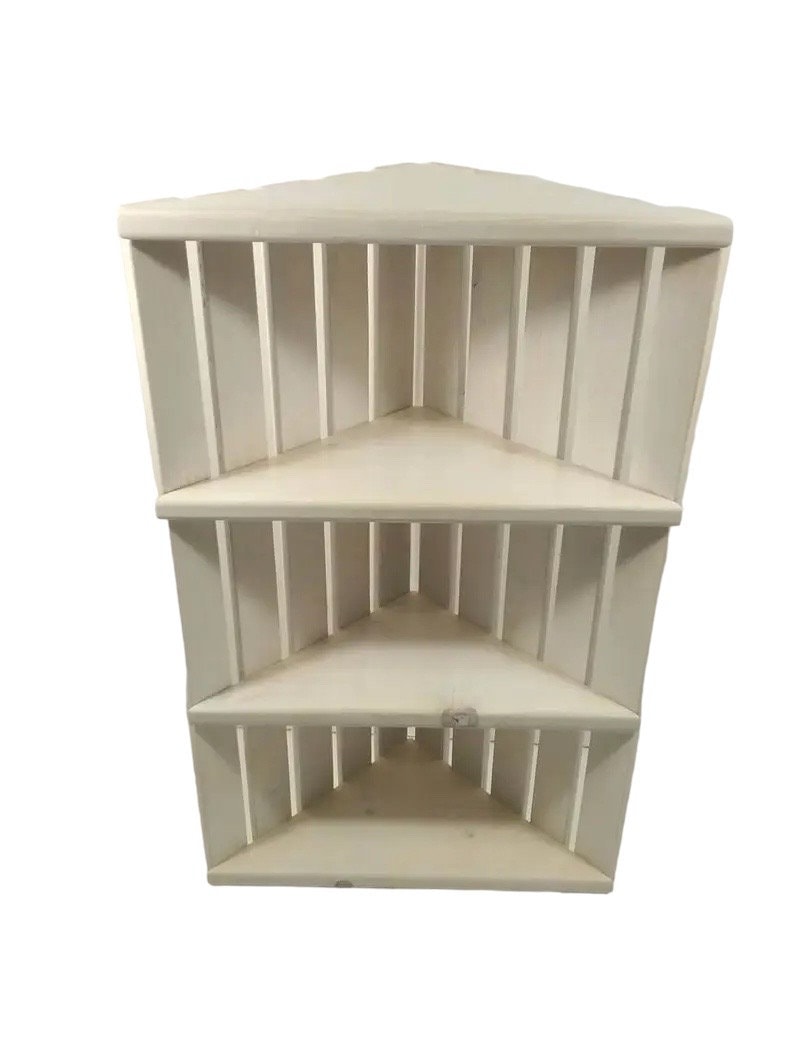 Wooden corner slatted shelf in white stain.  Three shelves.