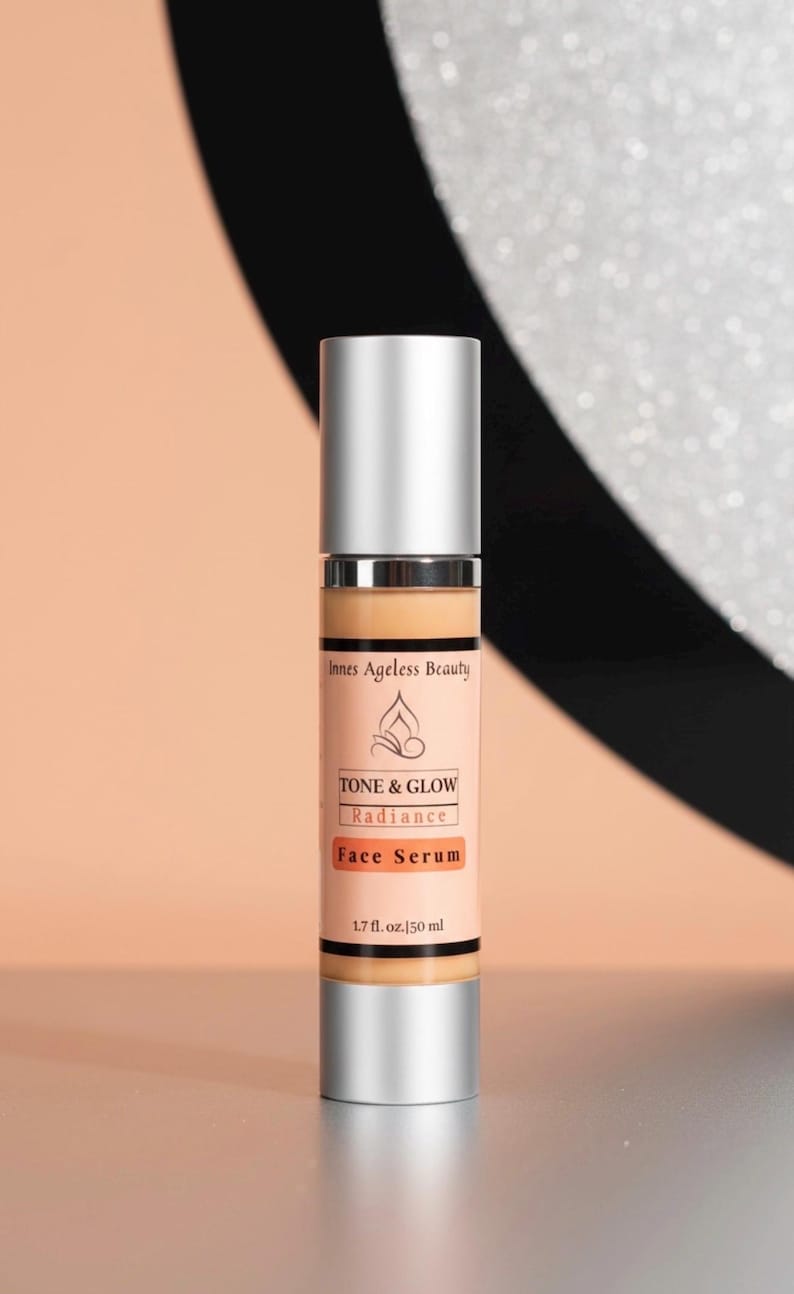 May include: A silver and beige face serum bottle with the text "Innes Ageless Beauty" and "TONE & GLOW Radiance Face Serum". The bottle contains 1.7 fl. oz. [50 ml] of product.