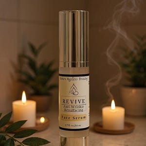 Revive anti wrinkle resurfacing face serum in gold airless pump bottle styled with spa candles and botanical skincare aesthetic for mature skin and nighttime skincare routines