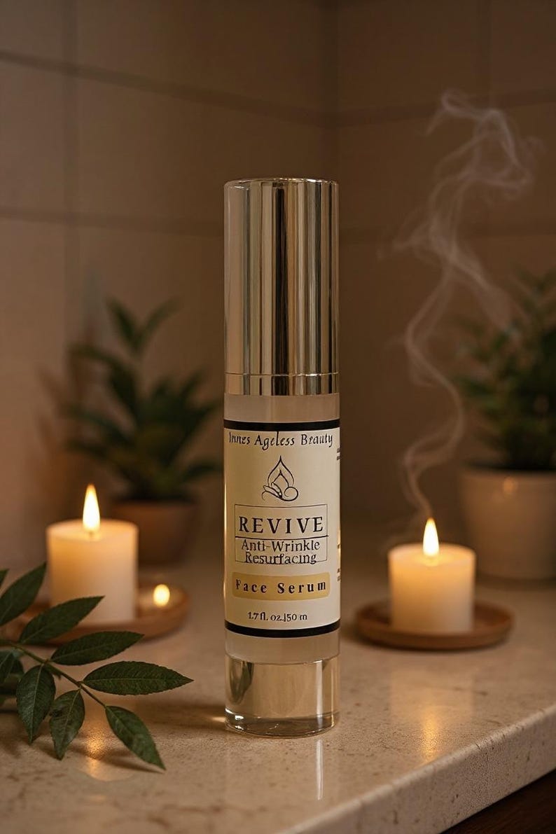 Revive anti wrinkle resurfacing face serum in gold airless pump bottle styled with spa candles and botanical skincare aesthetic for mature skin and nighttime skincare routines