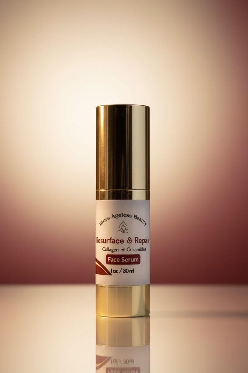 May include: A face serum bottle with a gold cap and base, and a white label. The label reads "Resurface & Repair Face Serum" with "Collagen & Ceramides" and "1 oz / 30ml". The product is from "Innes Ageless Beauty".