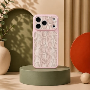 May include: A light pink smartphone case featuring a textured snakeskin pattern in shades of beige and cream. The case includes a raised camera module cutout with three circular lens openings and a small circular flash opening on the upper right side.