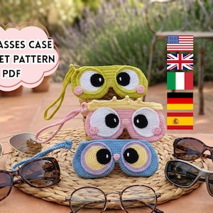 May include: Crocheted eyeglasses cases in green, pink, and blue, each with a whimsical eye design. The cases are displayed with various sunglasses and eyeglasses on a woven mat. Text on the image reads: EYEGLASSES CASE CROCHET PATTERN PDF.